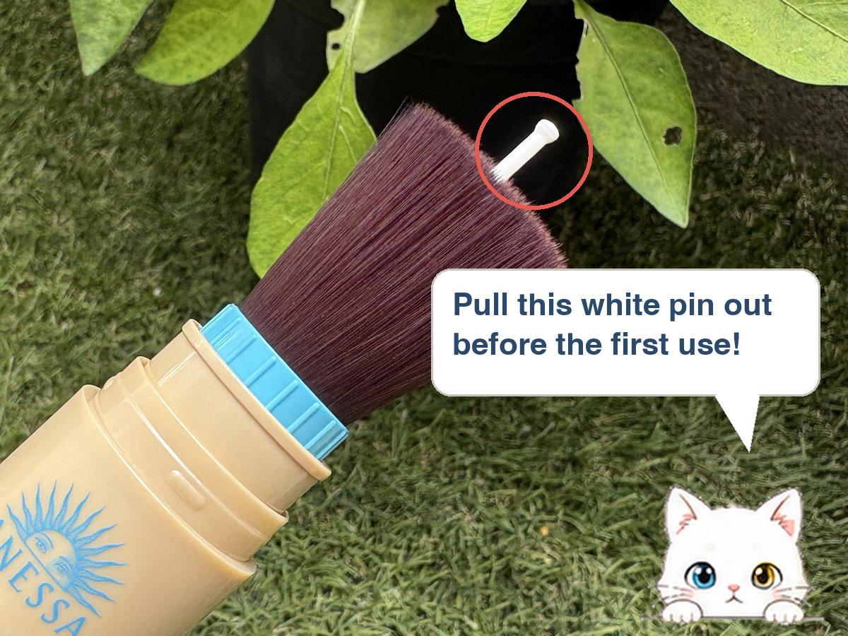Tip showing the white stopper pin to pull out of the ANESSA brush before first use
