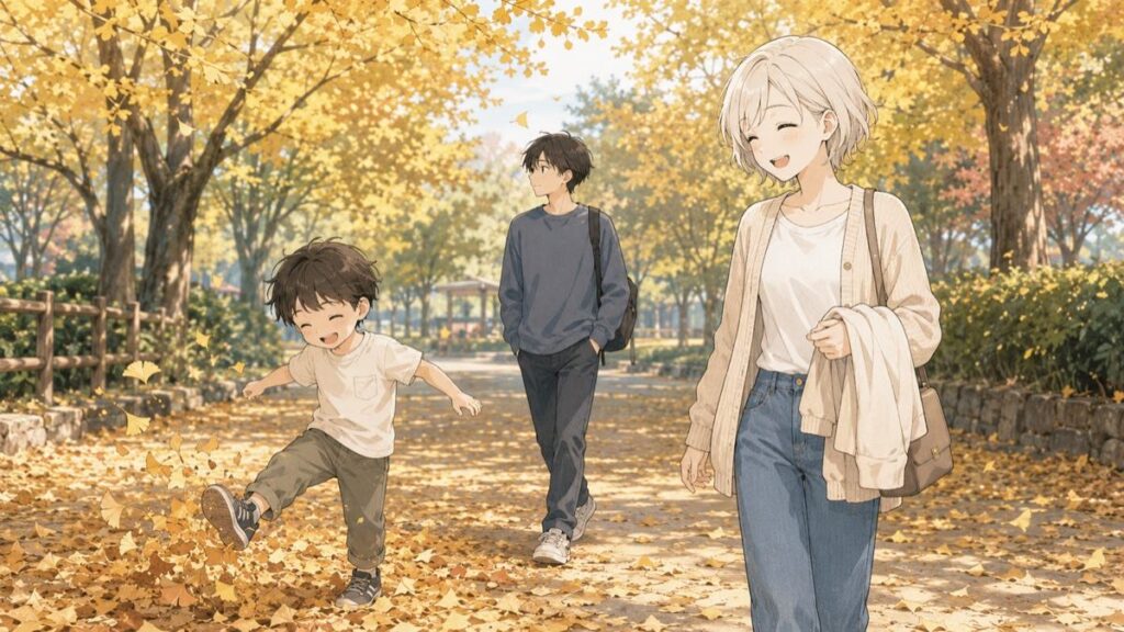 Mother holding a spare layer while her son plays in autumn leaves at a Japanese park
