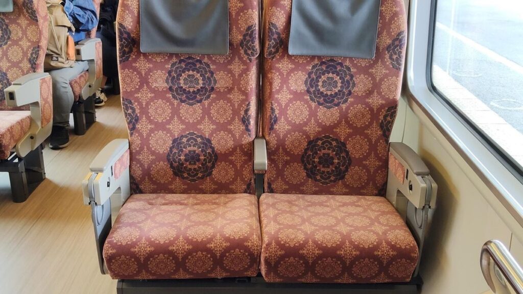 Patterned reserved seats inside the refurbished Mahoroba limited express